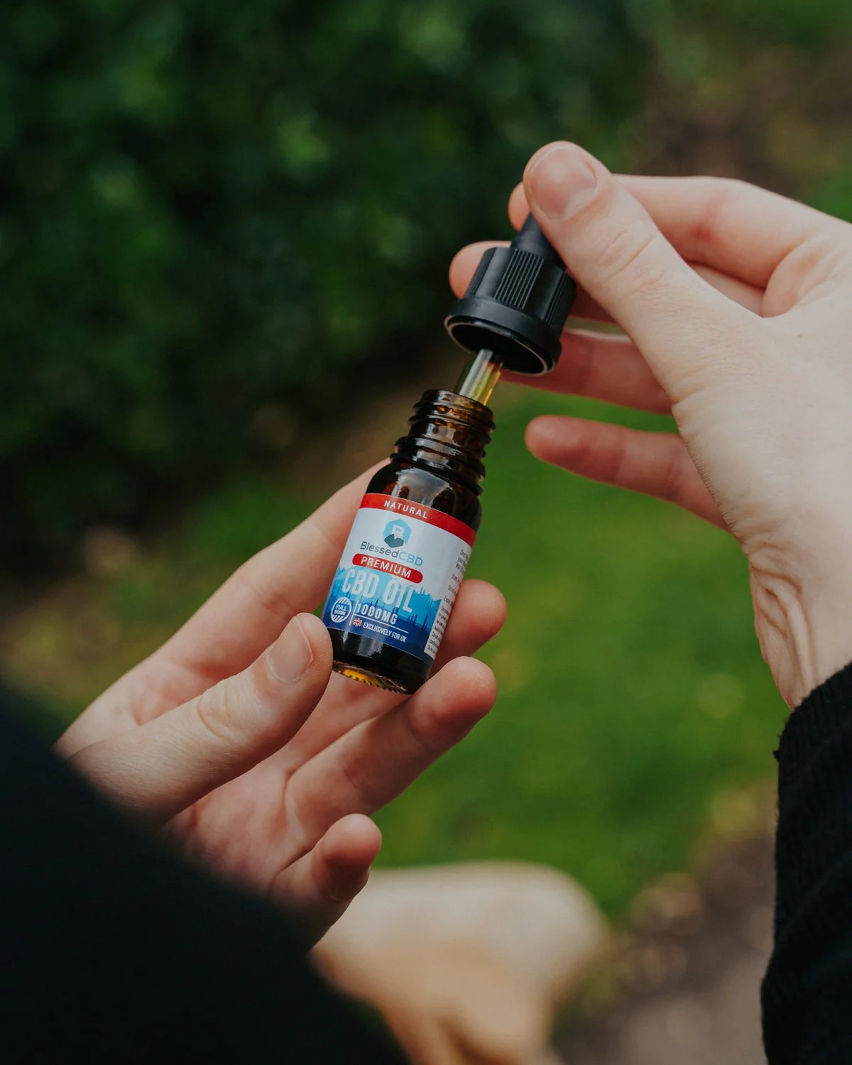 Blessed CBD 1000mg bottle being held outdoors